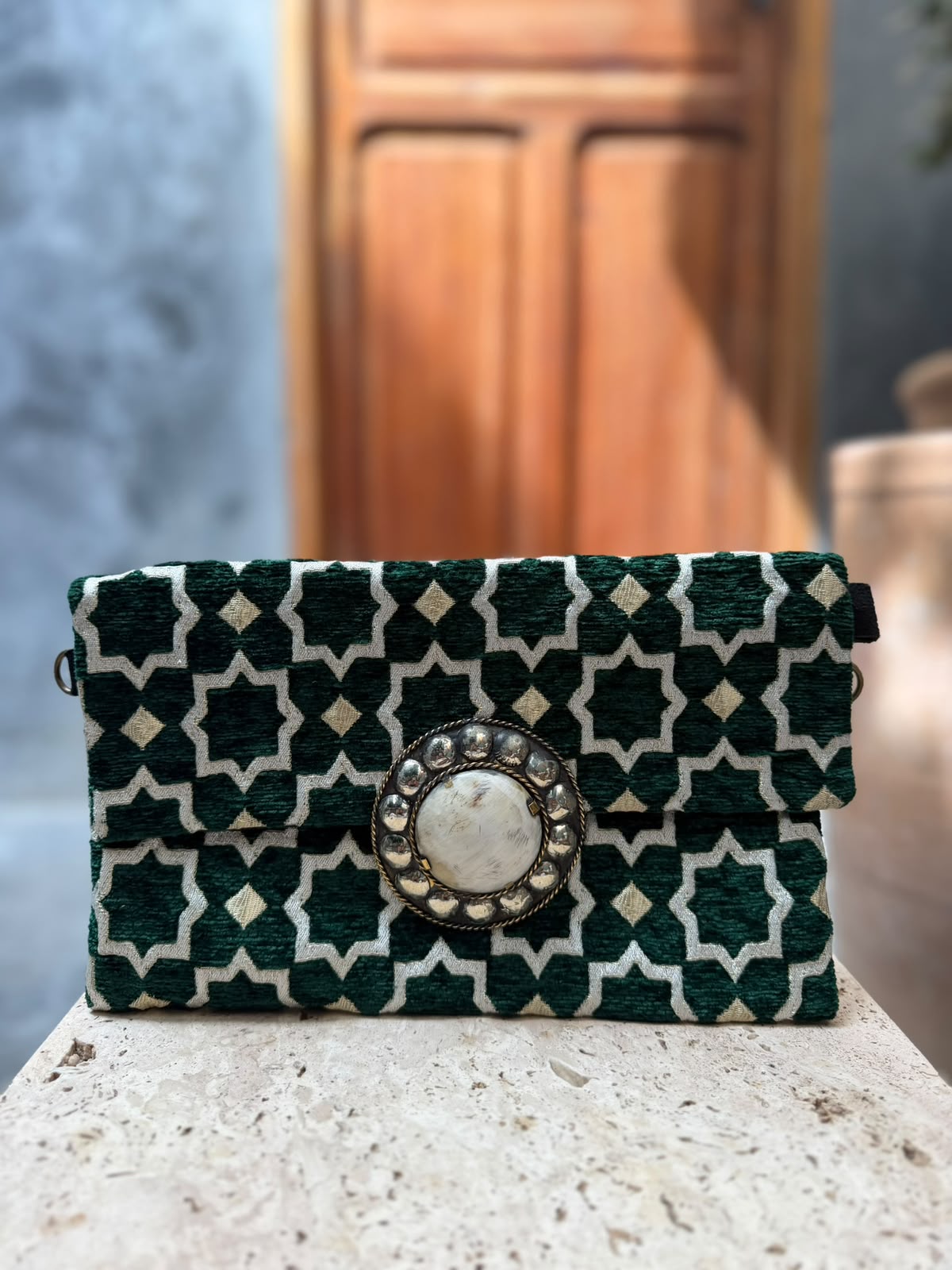 Deep green and cream star-patterned carpet bag with small cream diamonds and a pale circular centrepiece in a metallic surround