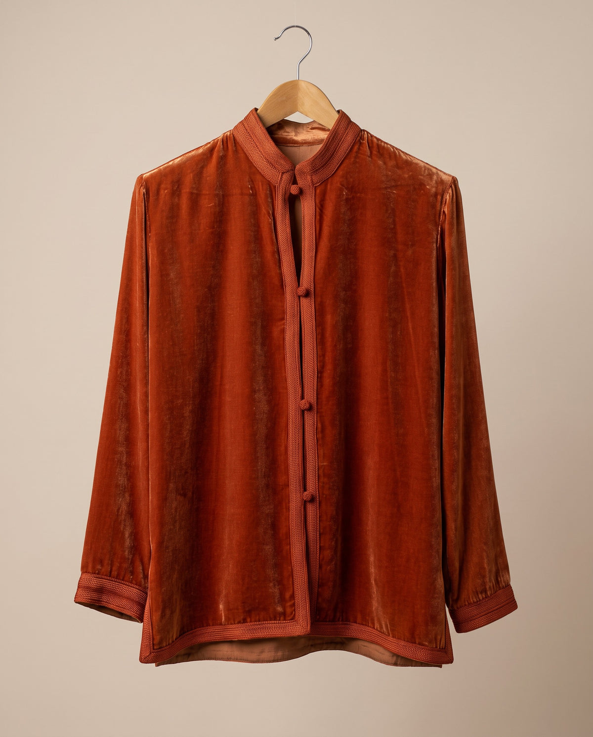 Women's burnt-orange jacket with stand collar, tonal trim and rounded front button details